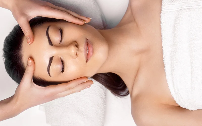 Woman receiving facial treatment