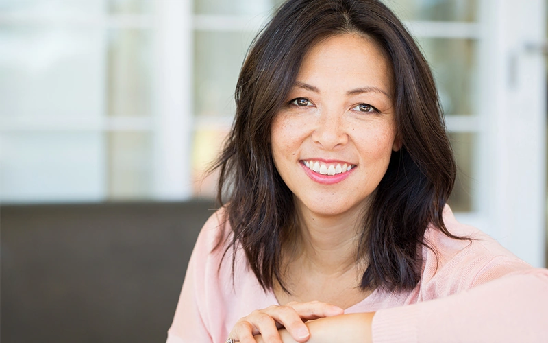 Pretty Asian woman smiling after treatment