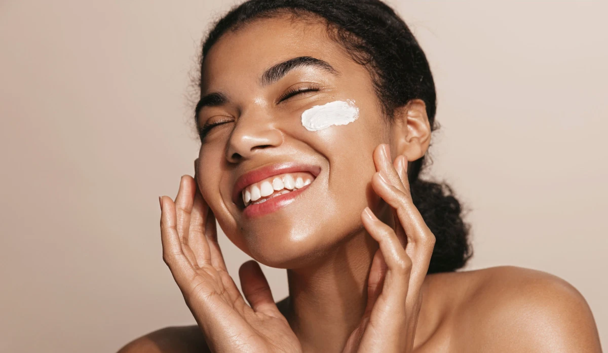 woman applying medical grade skincare to her glowing skin