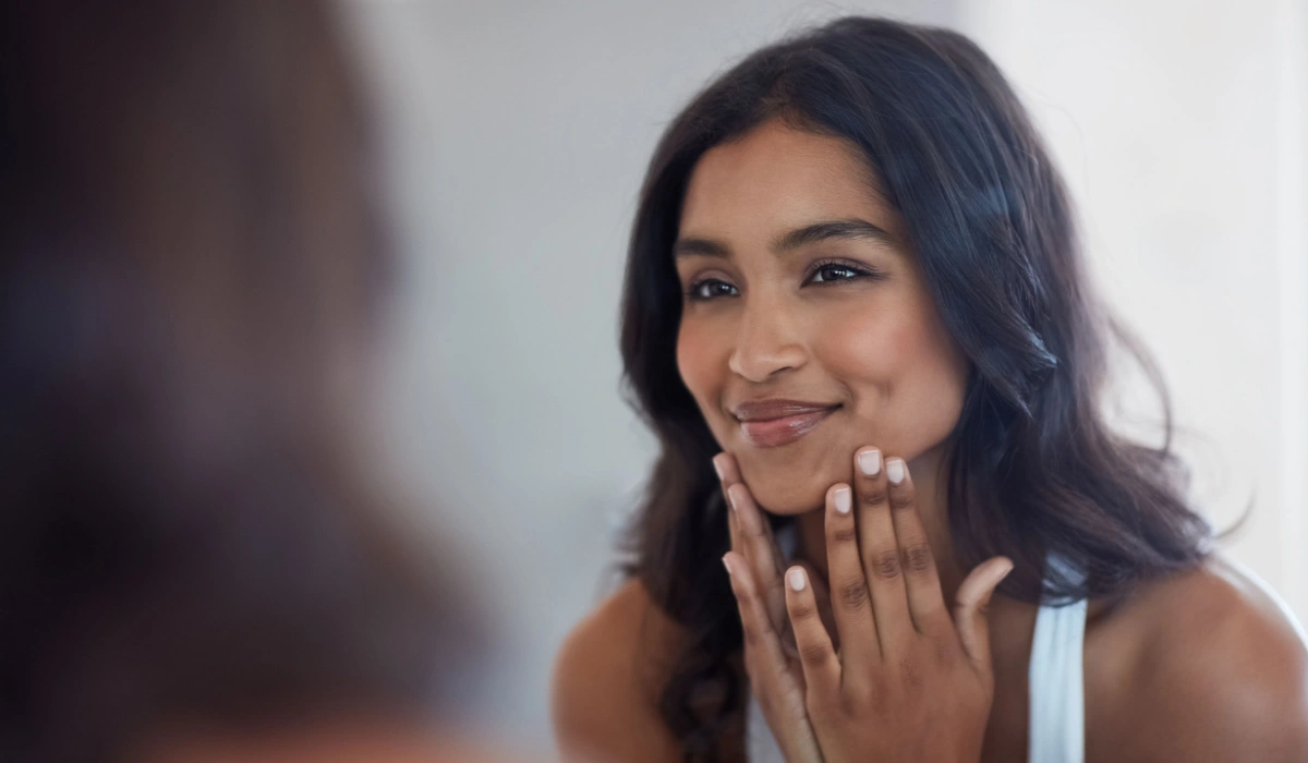 beautiful young woman looking in the mirror