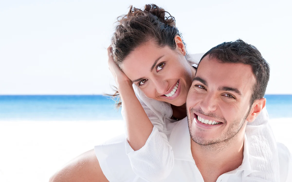 Beautiful man and woman at the beach